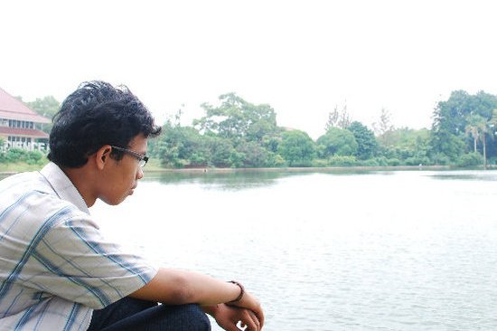 A person sitting in front of lake